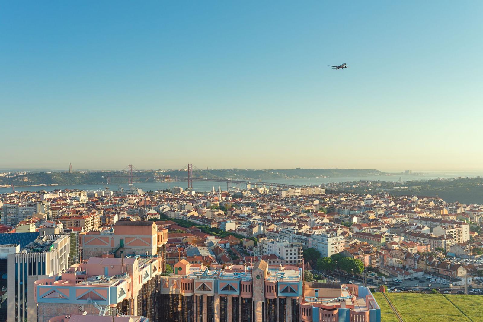 An Airplane Flying over a City